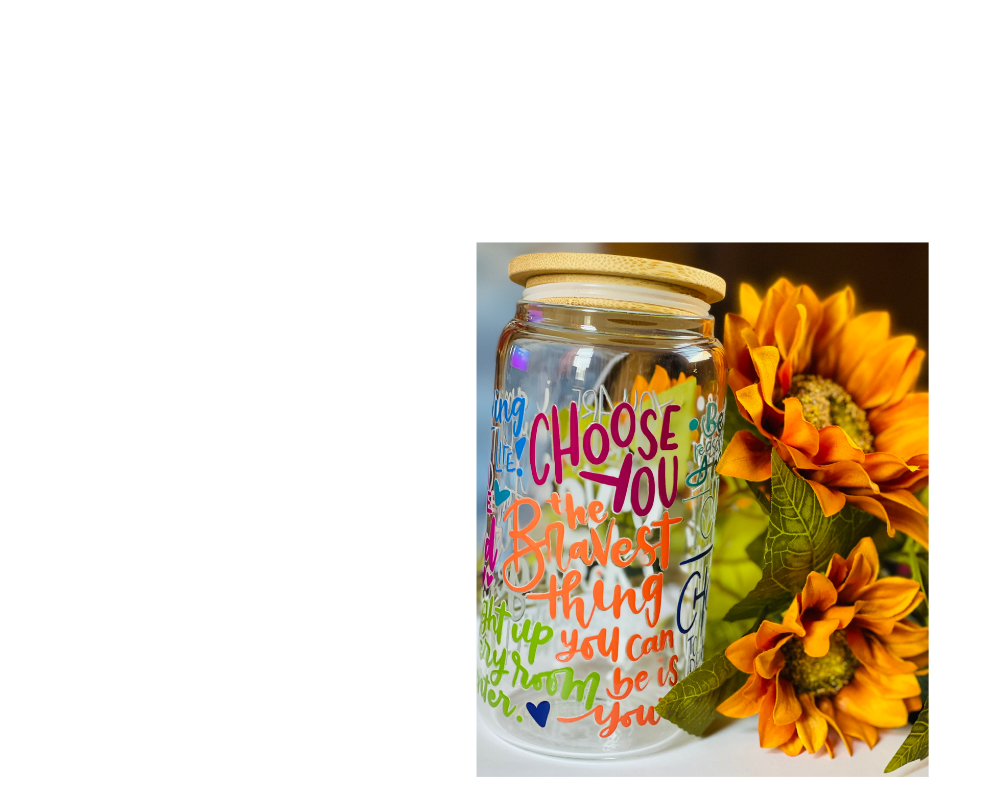 Decorative jar with colorful text and sunflowers on a white background