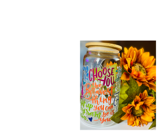 Decorative jar with colorful text and sunflowers on a white background